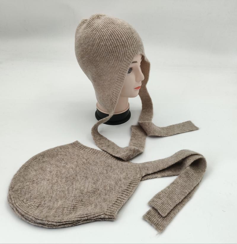 Beige ribbed knit bonnet hat with long tie straps displayed on a mannequin head alongside a flat-lay view of the same hat