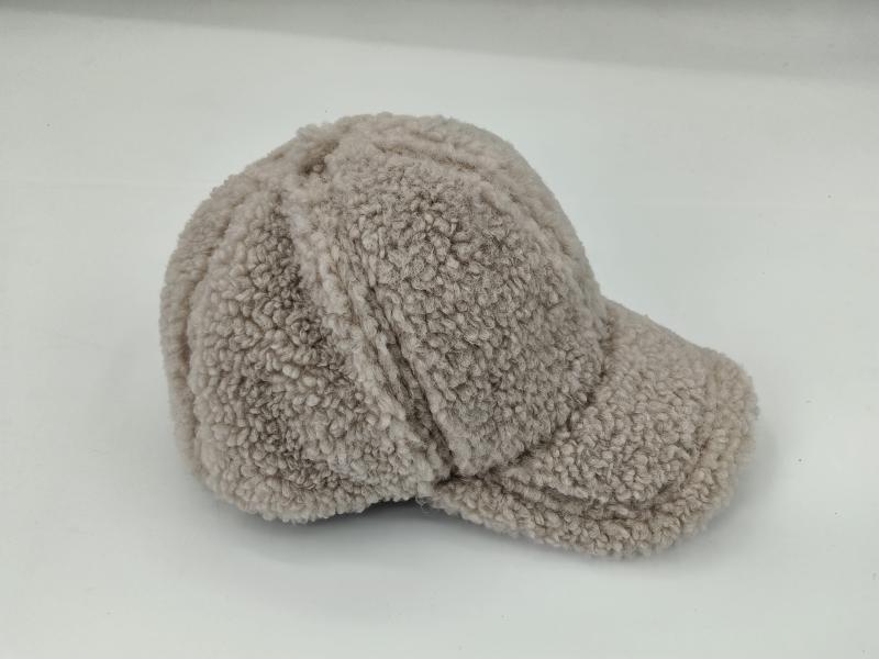 Beige sherpa fleece baseball cap with structured brim and panel seams, photographed on white background