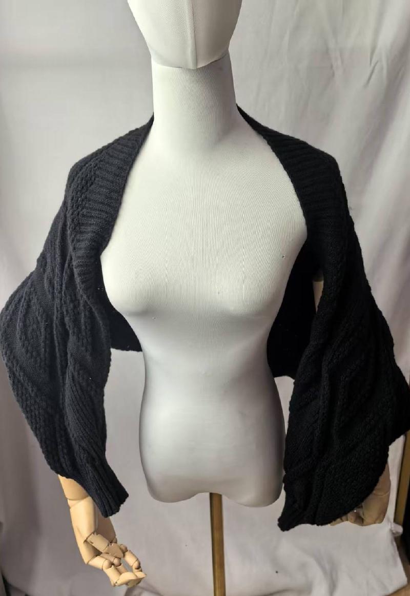 Black chunky cable knit bolero shrug cardigan with wide sleeves displayed on a dress form mannequin