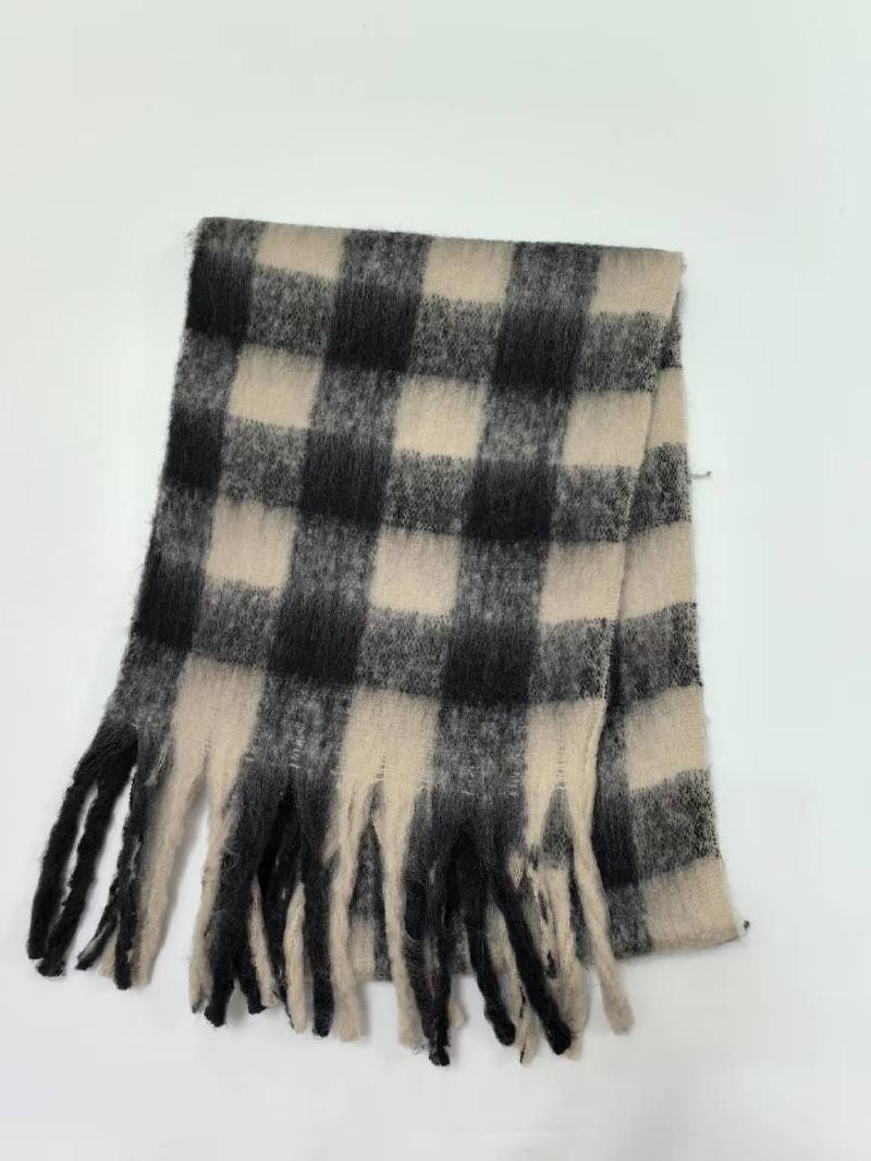 Folded black and cream large buffalo plaid winter scarf with tassel fringe ends on white background