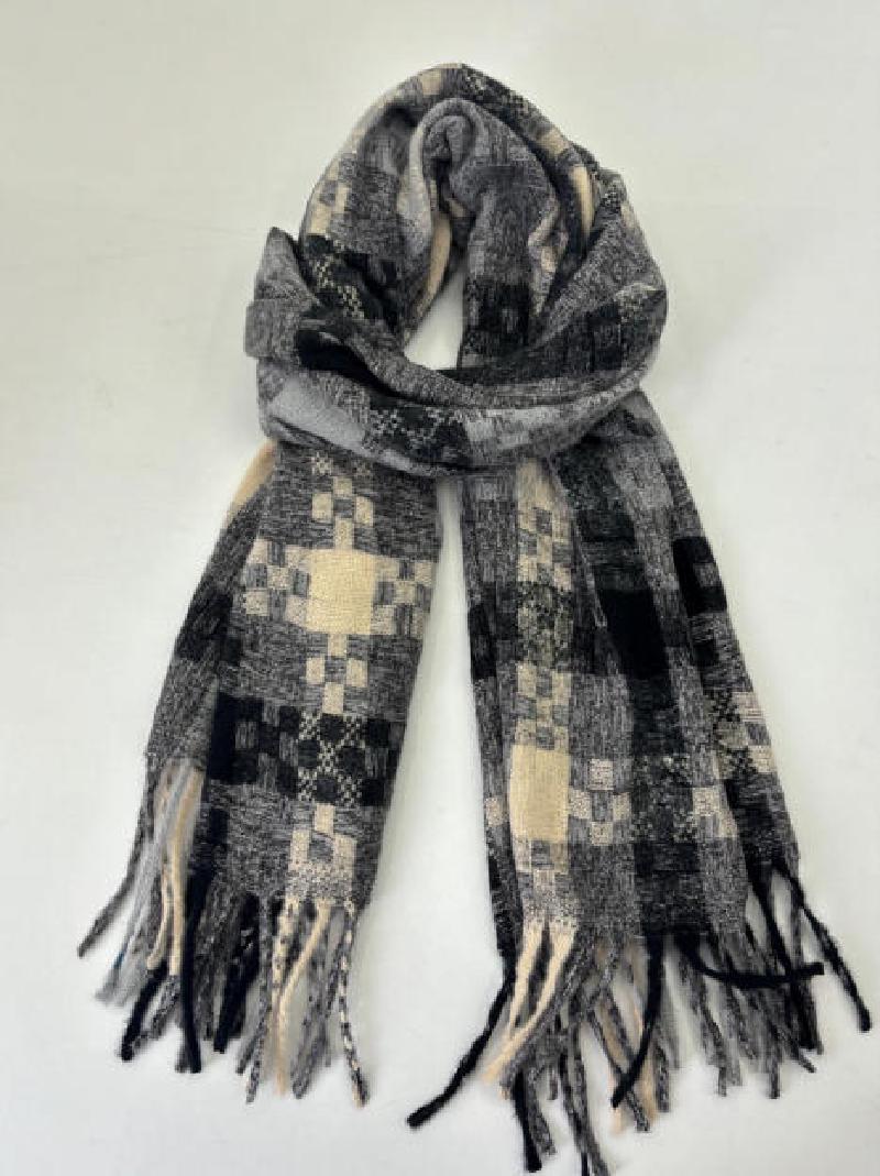Folded woven scarf in black, grey and cream patchwork check pattern with tassel fringe ends on white background