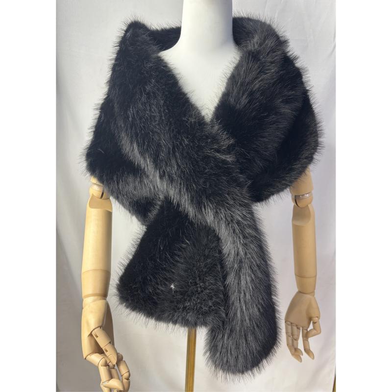 Black faux fur wrap shawl displayed on mannequin, featuring fluffy texture, silver-tipped fur and rhinestone accent