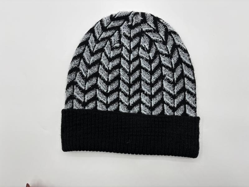 Black and grey chevron herringbone pattern knit beanie hat with solid black ribbed cuff, laid flat on white background