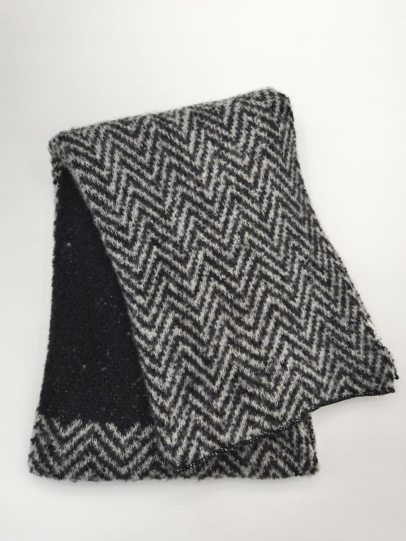 Folded black and grey chevron zigzag pattern knitted wool blend scarf with textured fuzzy finish on white background
