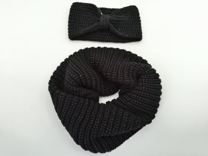 Black chunky knit infinity scarf coiled next to matching twist knot headband with multicolor metallic lurex threading