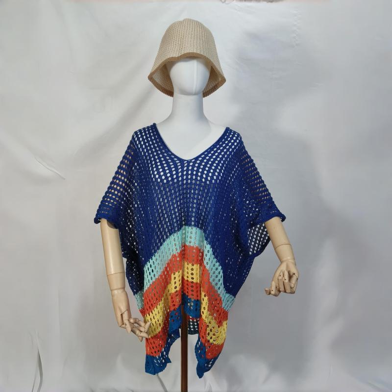 Mannequin wearing blue crochet open-knit poncho with rainbow stripe hem and beige bucket hat on white background