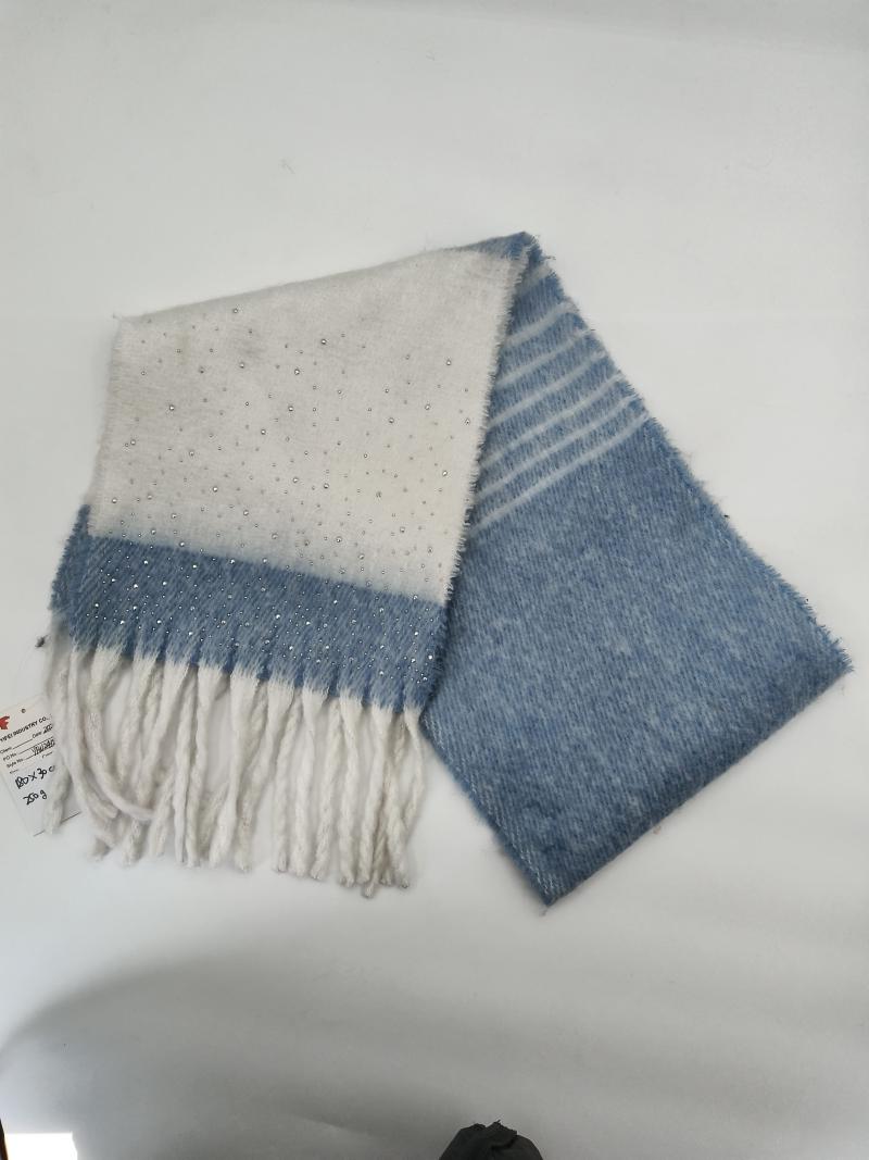 Folded blue and white ombre scarf with scattered rhinestones, fringe ends, and diagonal stripe pattern on soft fluffy fabric