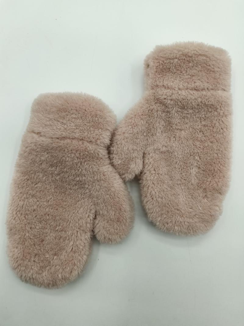 Pair of blush pink fluffy faux fur winter mittens laid flat on white background