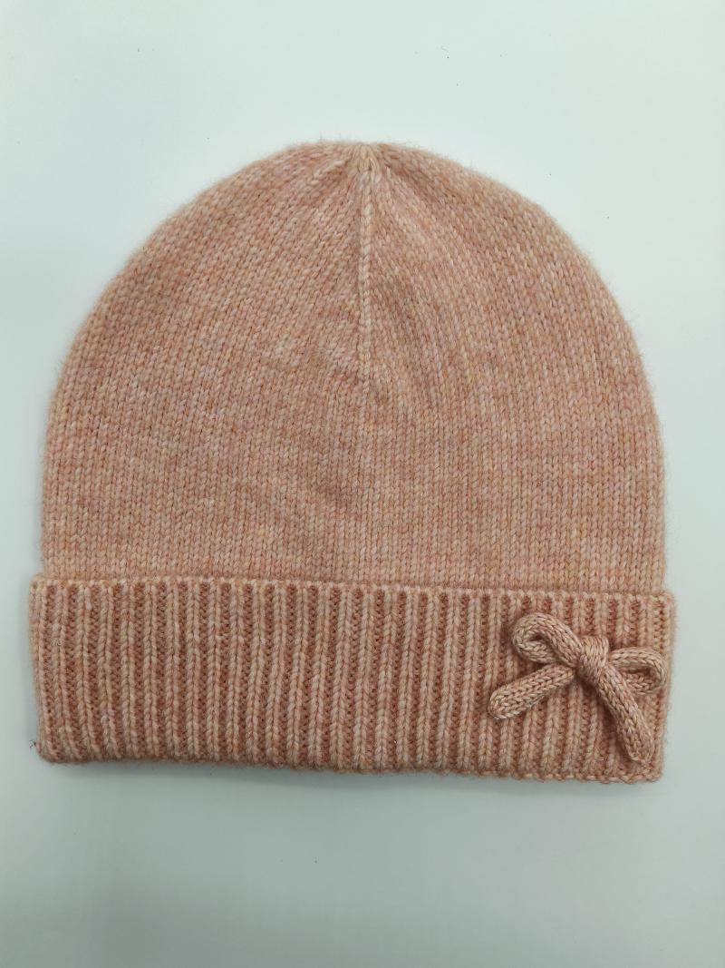 Blush pink marl knit beanie hat with ribbed cuff and small bow accent, laid flat on light background