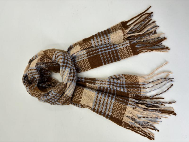 Woven plaid scarf in brown, blue, and cream with fringe ends, loosely knotted on white background