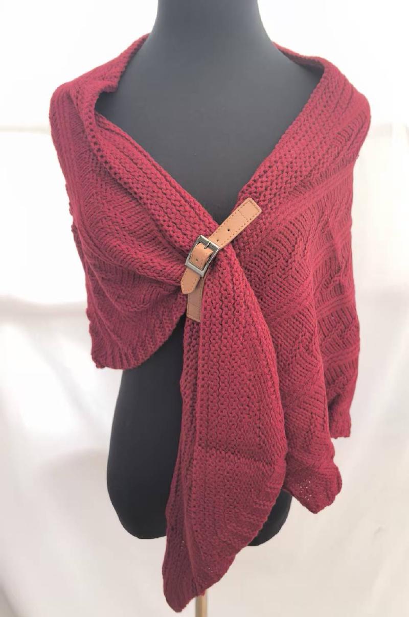 Burgundy chunky knit wrap shawl secured with a tan leather buckle clasp, draped on a mannequin torso