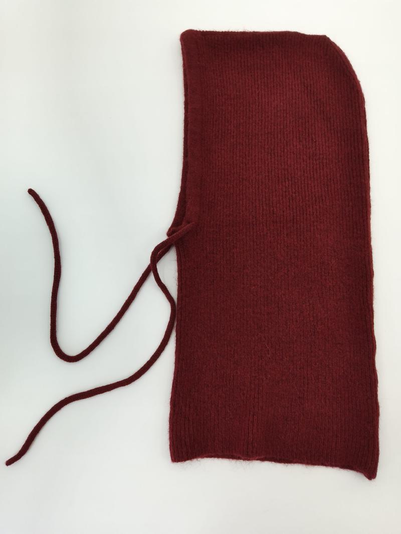 Deep red ribbed knit balaclava hood laid flat on white background with two long tie strings on the left side