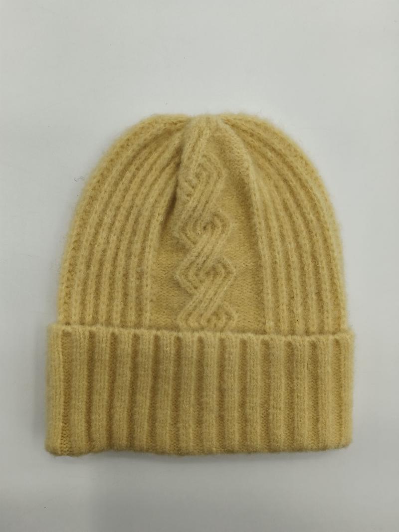 Butter yellow ribbed wool knit beanie hat with geometric cable knit pattern and folded cuff, laid flat on white background