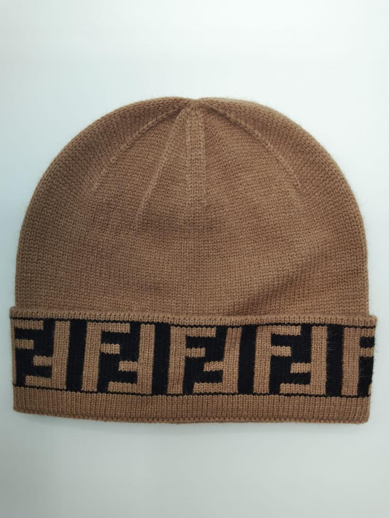 Camel brown fine knit beanie hat with folded cuff featuring repeating black geometric monogram logo pattern