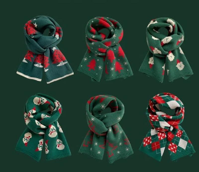 Six green and red knitted Christmas scarves with holiday patterns including trees, snowmen, reindeer, snowflakes, and argyle designs
