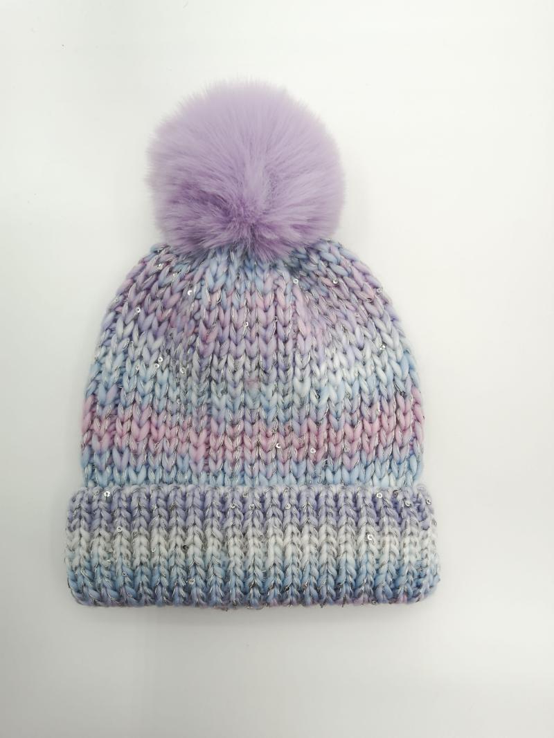 Chunky knit beanie hat in pastel purple blue and pink ombre with silver sequins and lavender faux fur pom-pom on white background