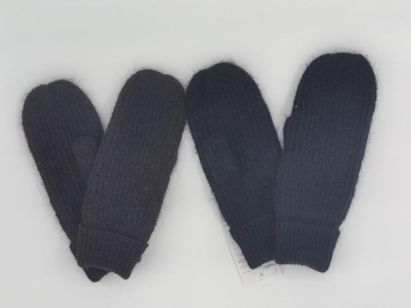 Two pairs of chunky knit mittens in dark charcoal gray and navy blue laid flat on white background with product tag
