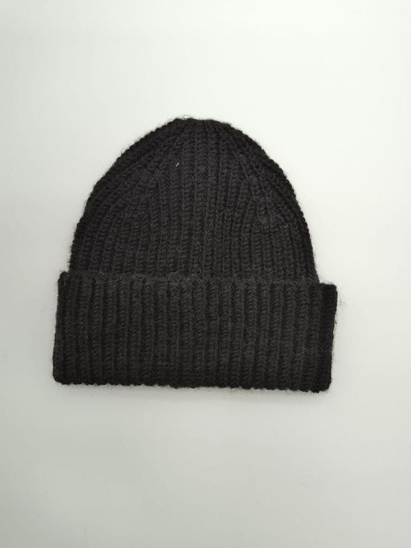 Black chunky ribbed knit beanie hat with folded cuff, laid flat on white background, handcrafted wool blend