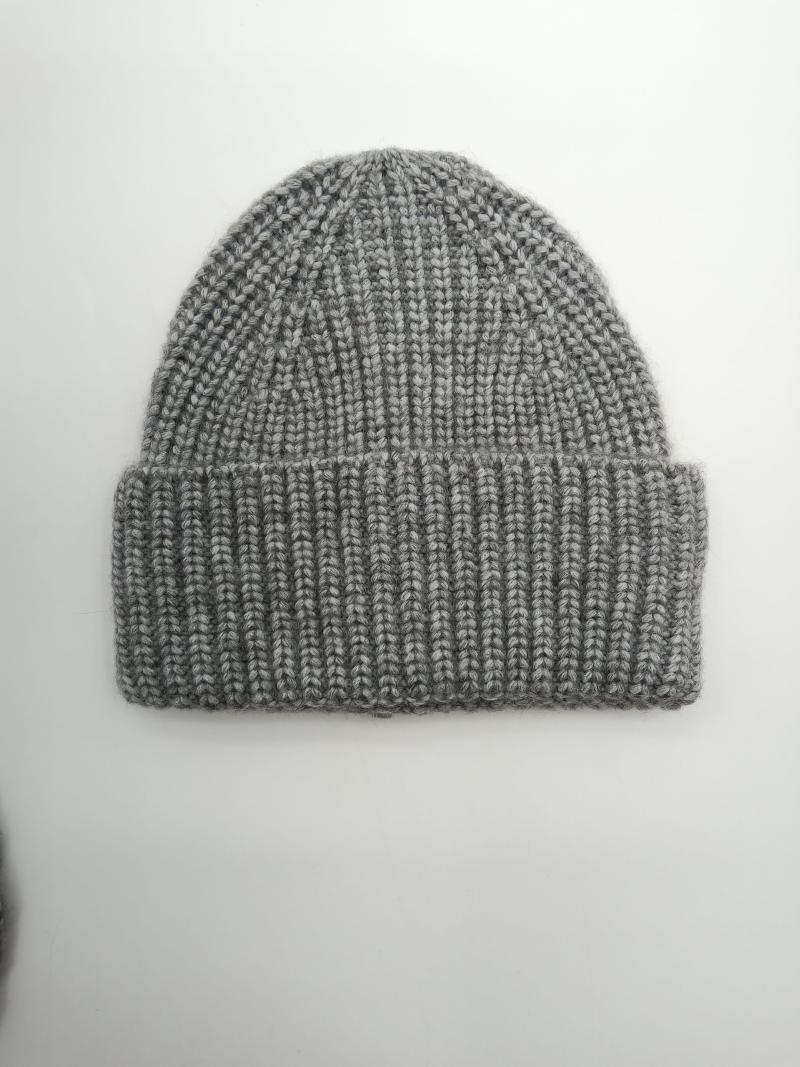 Flat lay of a heather grey chunky ribbed knit beanie hat with folded cuff on white background