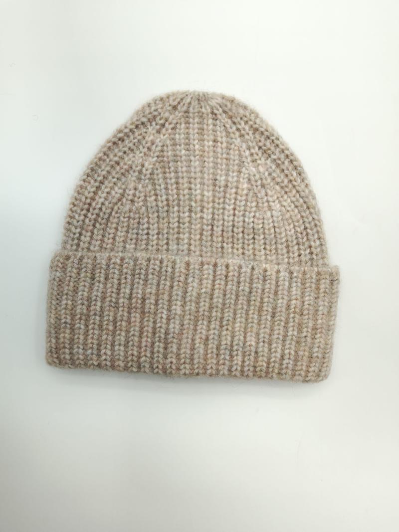 Flat lay of a chunky ribbed knit beanie hat in oatmeal and beige marl with a folded cuff on white background