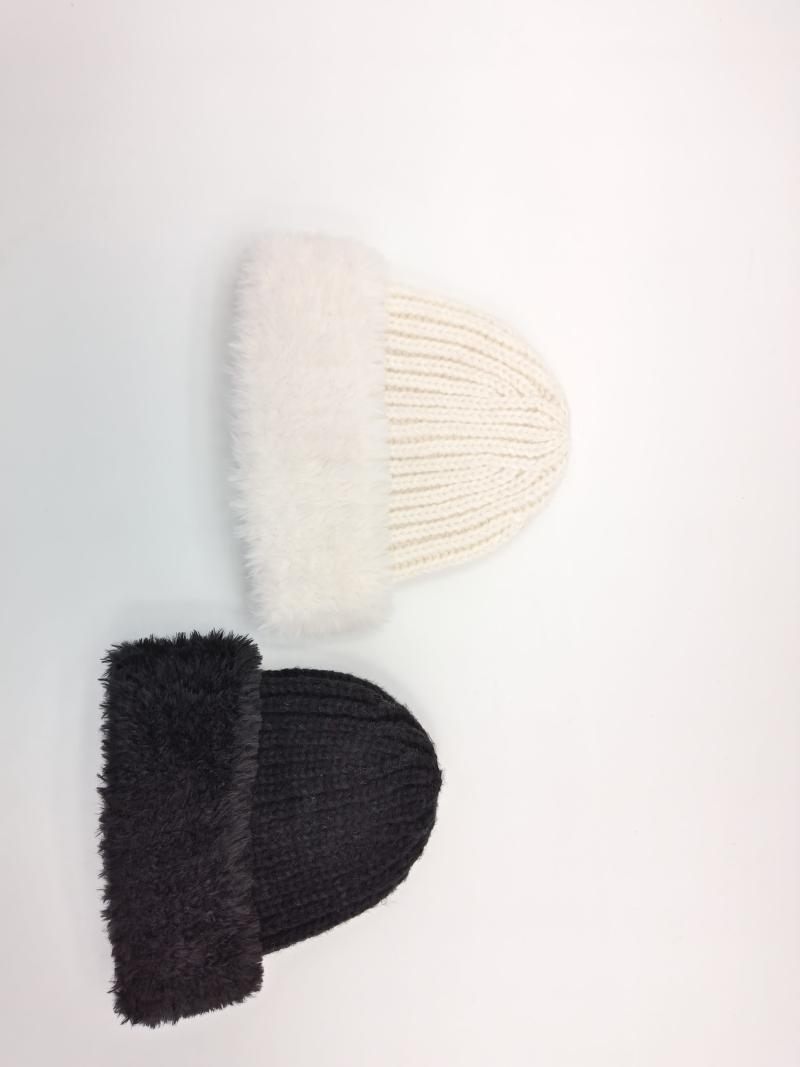 Two chunky ribbed knit beanies with fluffy faux fur folded cuff in cream white and dark charcoal, flat lay on white background