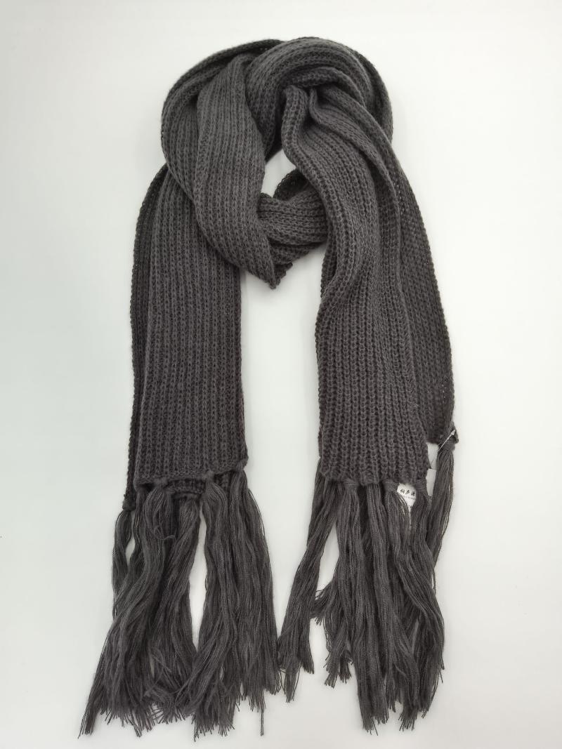 Dark gray chunky ribbed knit winter scarf with long fringe tassels displayed folded on white background