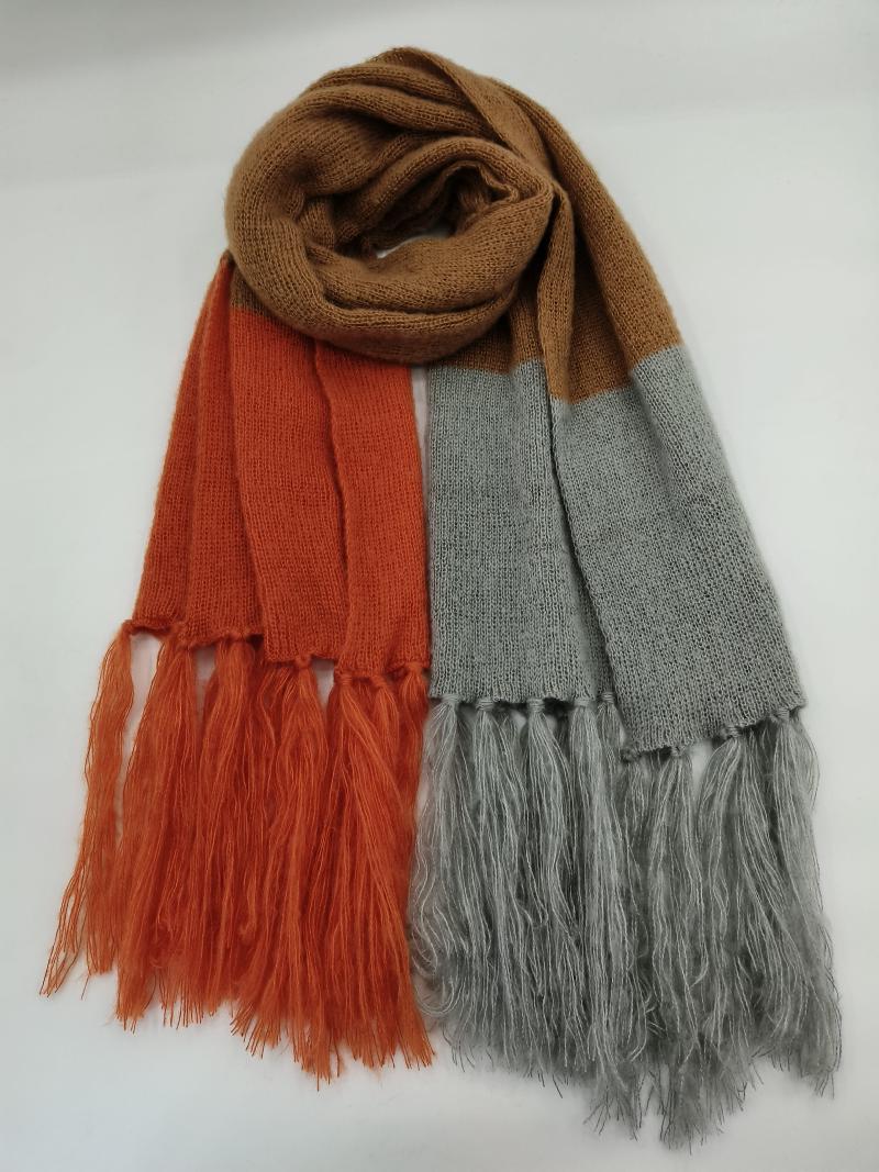 Color block knit scarf in rust orange, grey, and camel with long fringe ends, laid flat on white background