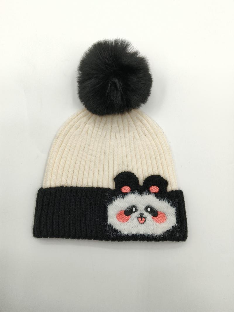 Cream and black ribbed knit winter beanie hat featuring a cute panda face patch and dark faux fur pompom on top