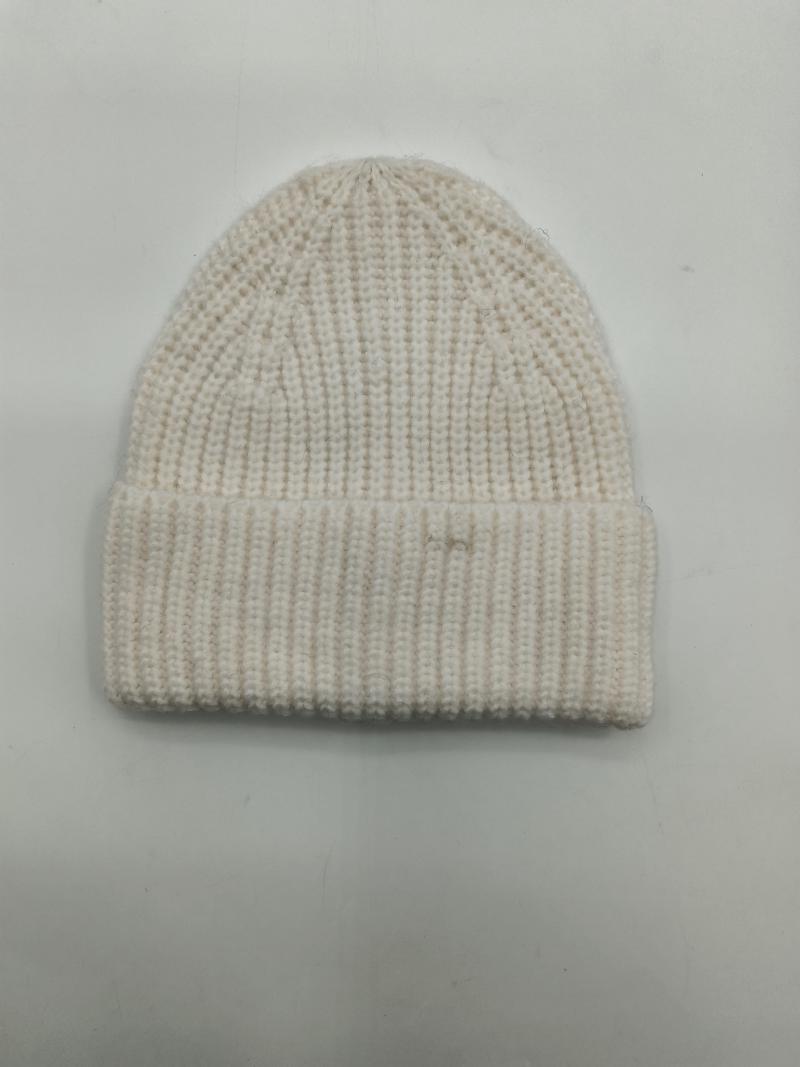 Cream off-white chunky ribbed knit beanie hat with fold-over cuff laid flat on white background