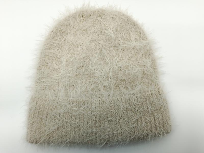 Cream beige fuzzy eyelash yarn knit beanie hat with ribbed cuff on white background