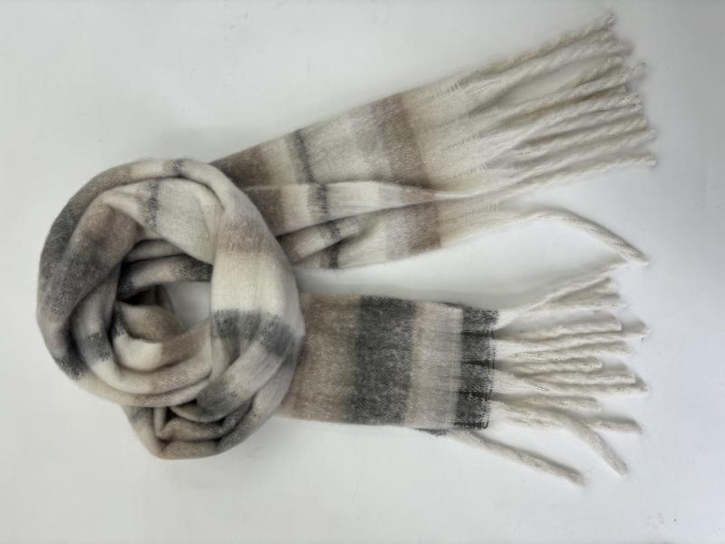 Cream and grey plaid brushed winter scarf with white fringe ends, loosely looped on white background