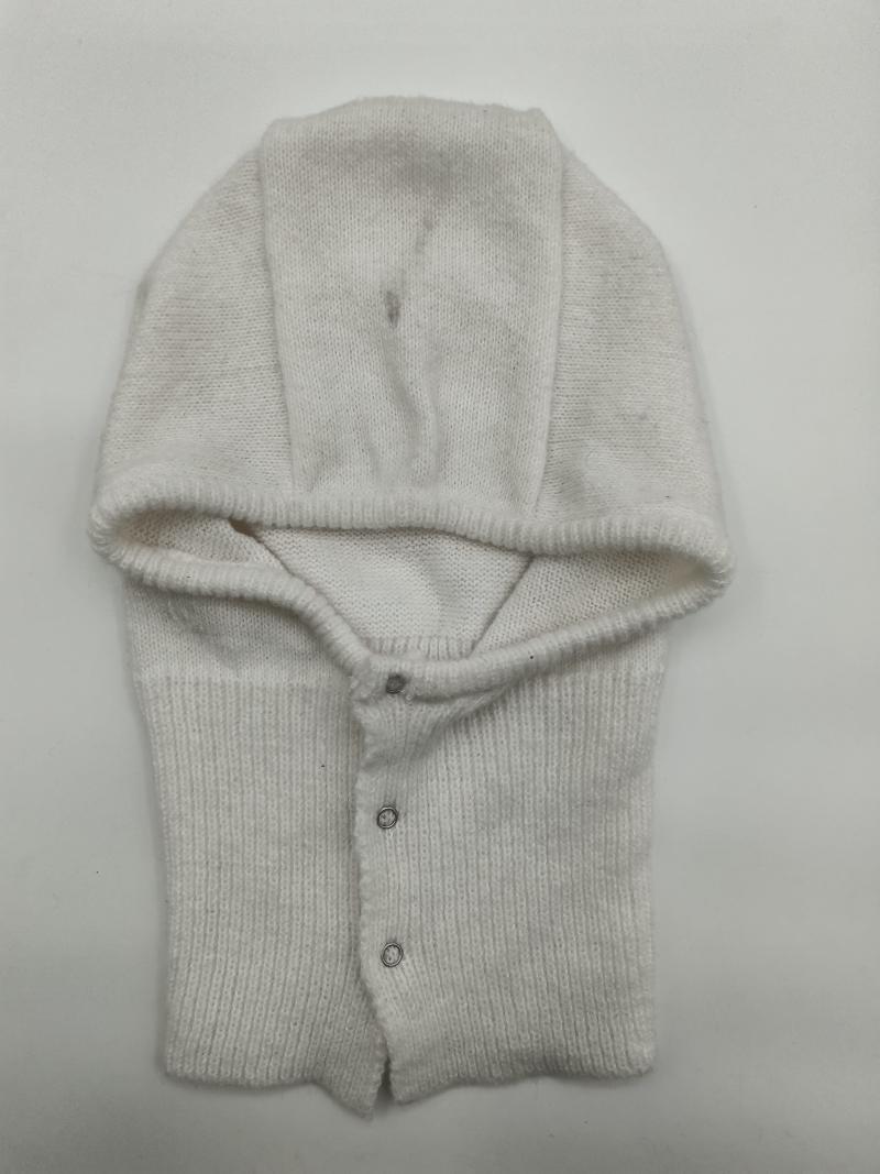 Cream white knitted baby balaclava helmet with fold-over hood and silver snap buttons, laid flat on white background