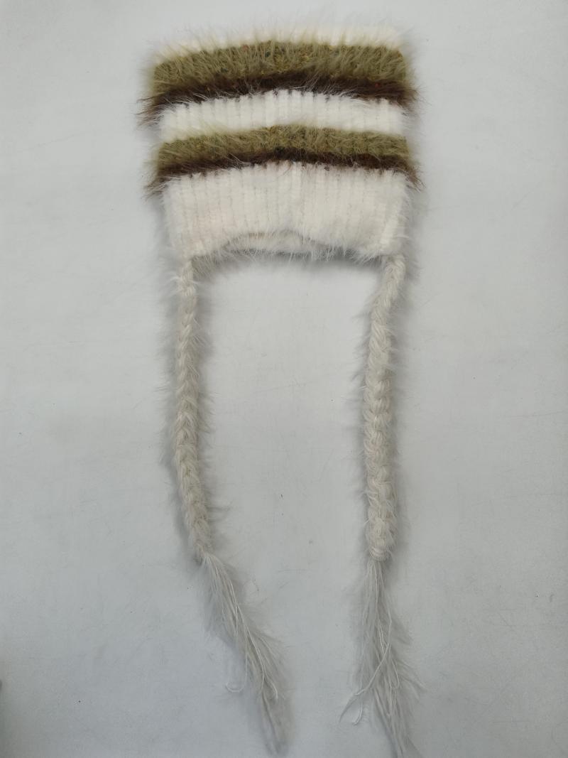 Cream and olive green fuzzy striped knit winter hat laid flat with two long braided tassel ties on white background