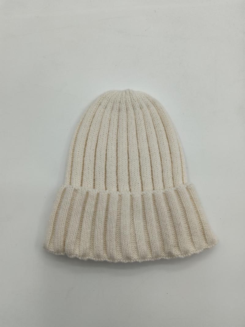 Cream off-white ribbed knit winter beanie hat with folded cuff brim, laid flat on white background
