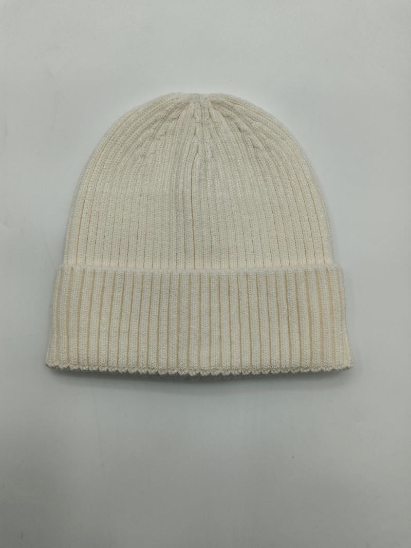 Cream off-white ribbed knit cuffed beanie hat laid flat on white background, showing fine rib texture and folded brim
