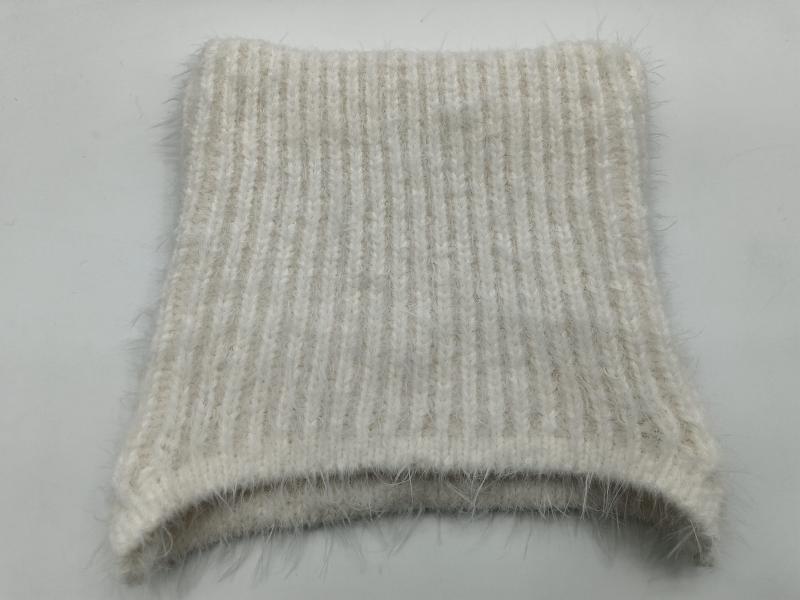 Close-up of a cream and beige ribbed knit fabric swatch with soft mohair halo texture, folded flat on white background