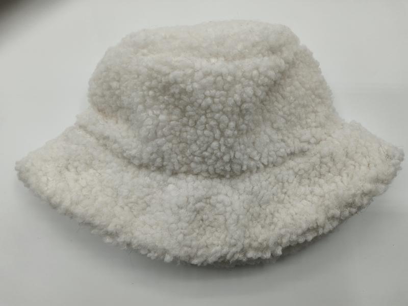 Cream white sherpa fleece bucket hat with fluffy boucle texture, placed on white background, soft winter accessory