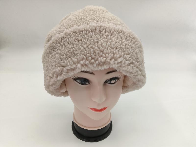 Cream off-white sherpa fleece bucket hat displayed on a female mannequin head against white background