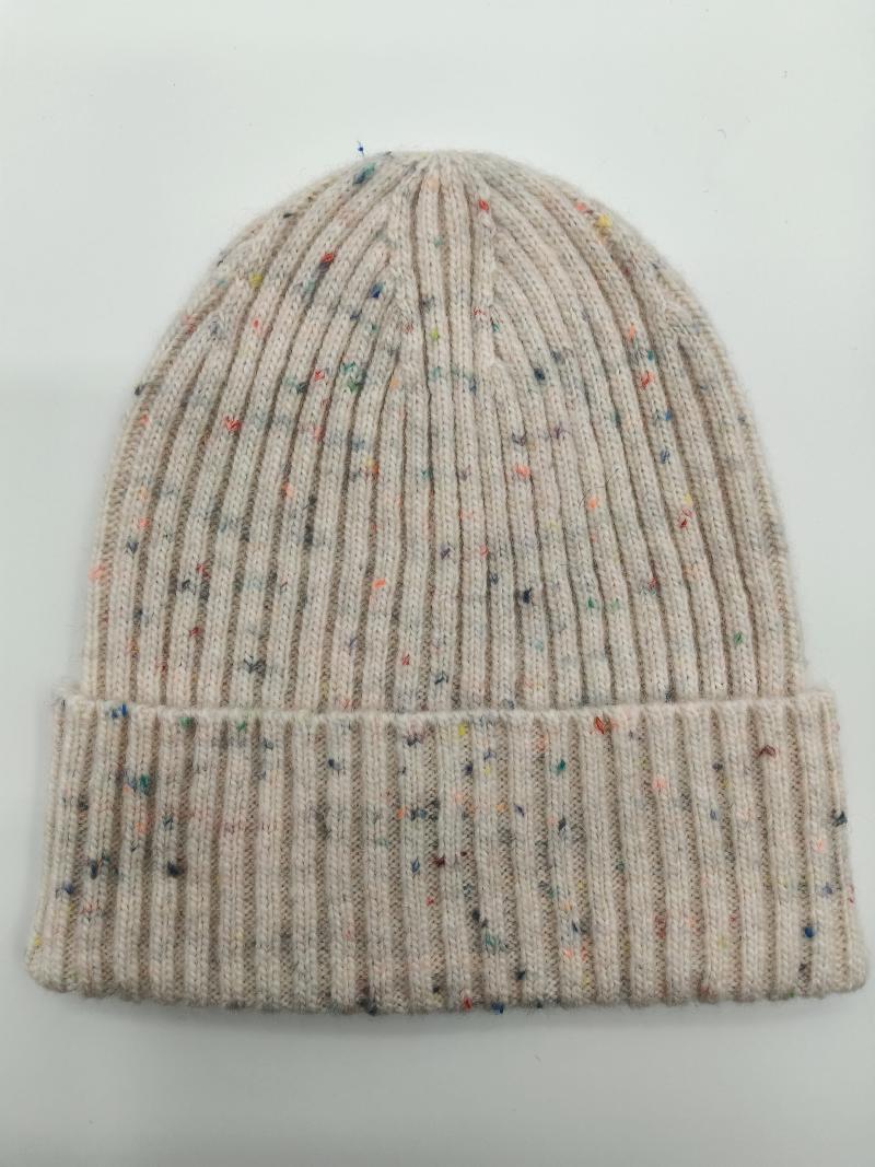 Cream ribbed knit beanie hat with multicolor confetti speckles and folded cuff, laid flat on white background