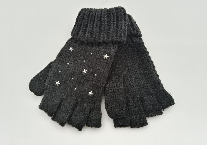 Pair of dark grey chunky knit fingerless gloves decorated with silver star studs and crystal embellishments on a white background