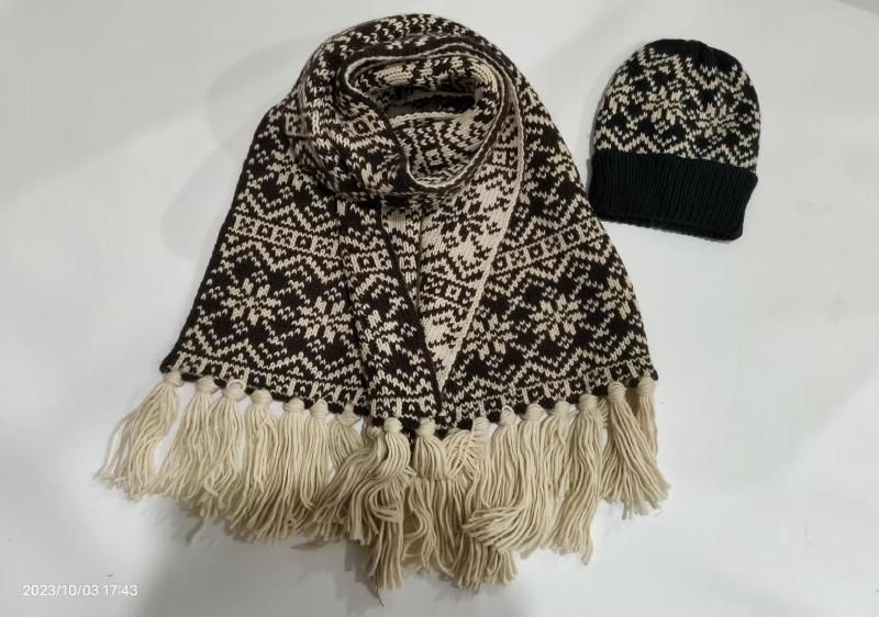 Brown and cream Fair Isle knit scarf with fringe tassels and matching snowflake beanie hat set on white background