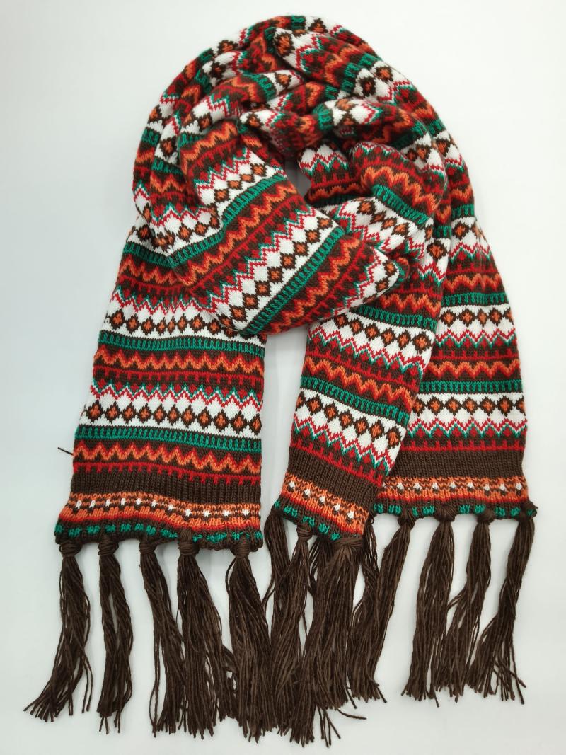 Colorful Fair Isle knitted scarf with red, green, orange, white, and brown geometric patterns and dark brown fringe ends