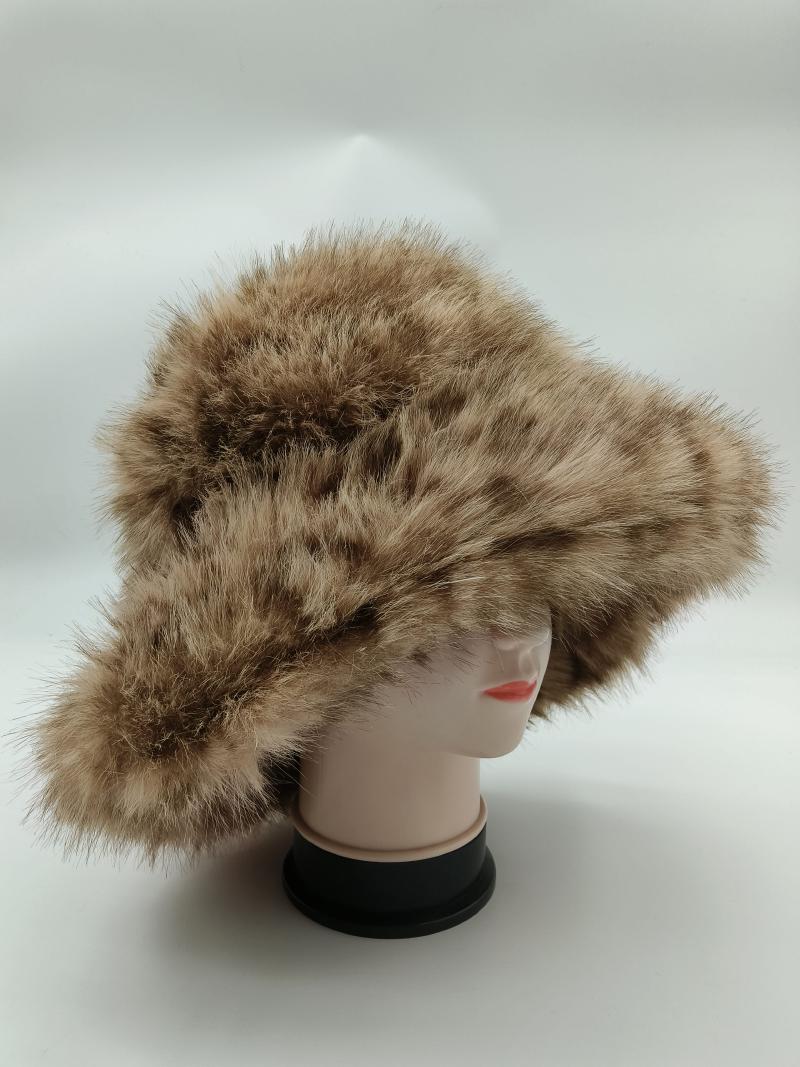 Tan and brown spotted faux fur wide brim bucket hat displayed on a white mannequin head against a light background