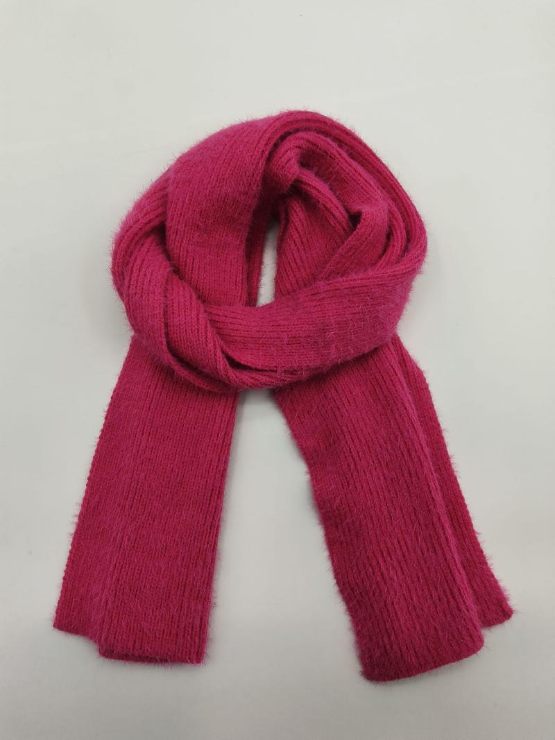 Fuchsia pink ribbed knit scarf folded in a loop on white background, soft fuzzy textured yarn
