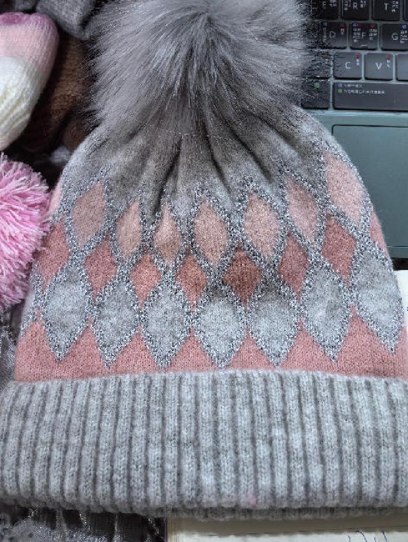 Gray and pink argyle pattern knit winter beanie hat with large faux fur pom pom on top