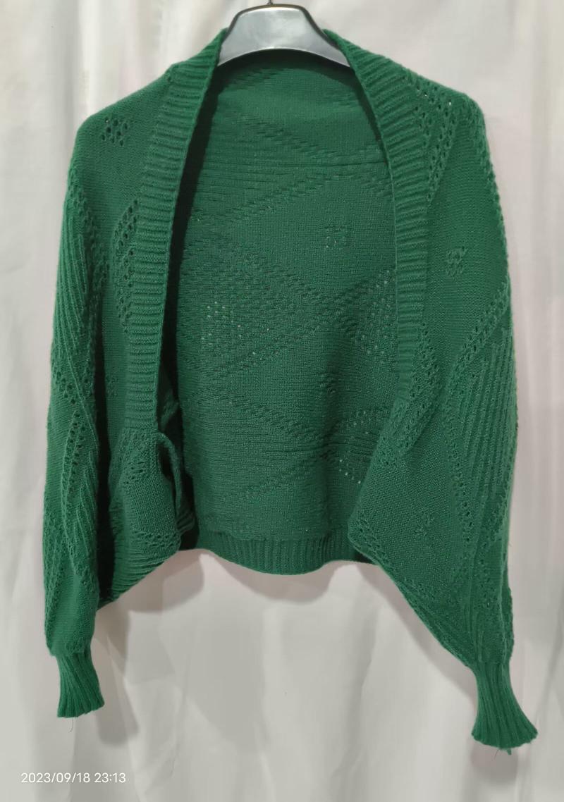 Green open-front knitted cardigan with diamond lace pattern and ribbed cuffs displayed on a hanger against white background
