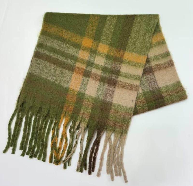 Folded green, gold, and beige plaid wool-blend scarf with twisted fringe tassels on white background