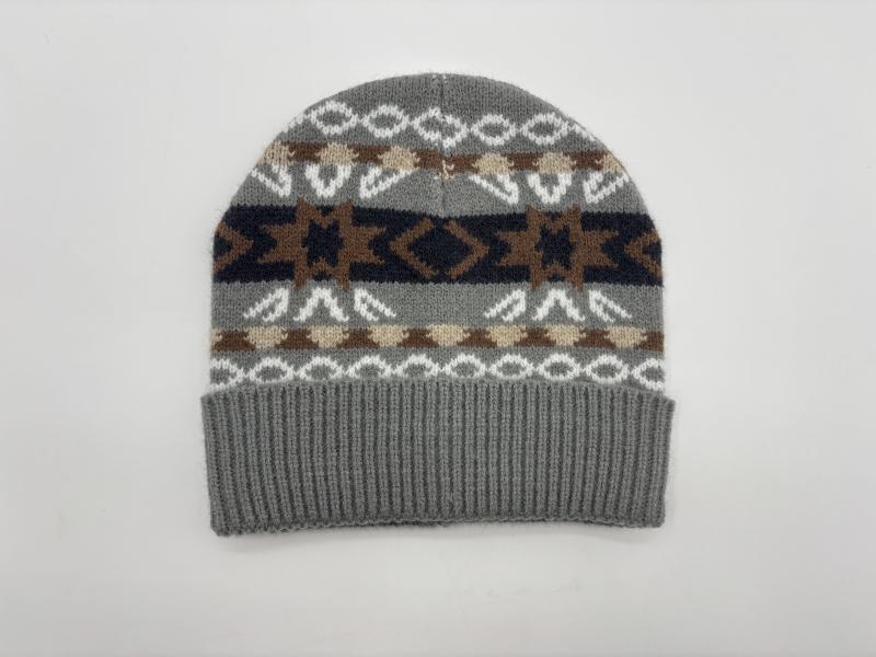 Grey knit beanie hat with Southwestern geometric pattern in brown, navy, cream, and white with ribbed cuff