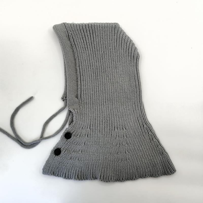 Grey ribbed knit balaclava hood with adjustable tie strings and two black button closures on white background