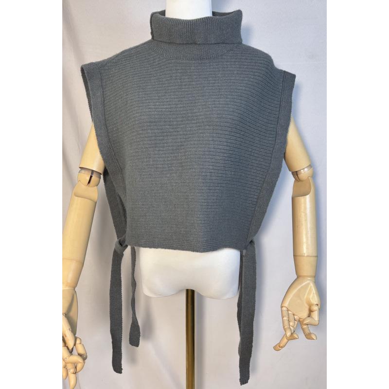 Grey ribbed knit sleeveless turtleneck sweater vest with side tie closures displayed on a wooden mannequin